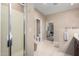 Bathroom featuring walk-in shower, tile floors, and access to Primary bedroom at 14000 N 94Th St # 1118, Scottsdale, AZ 85260