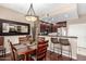 Dining area with dark wood floors, modern lighting, and a view of the kitchen at 14000 N 94Th St # 1118, Scottsdale, AZ 85260