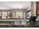 Kitchen with granite countertops, stainless steel sink, coffee maker, and a view into the living area at 14000 N 94Th St # 1118, Scottsdale, AZ 85260