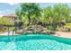 Beautiful waterfall feature enhances this inviting community pool surrounded by lush landscaping at 14000 N 94Th St # 1118, Scottsdale, AZ 85260