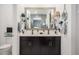 Modern bathroom with a double sink vanity and stylish decor at 14296 W Surrey Dr, Surprise, AZ 85379