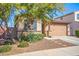 Charming single-story home featuring a desert landscape, a two-car garage, and a stone-accented facade at 14296 W Surrey Dr, Surprise, AZ 85379