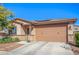 Charming single-story home featuring a desert landscape, a two-car garage, and a stone-accented facade at 14296 W Surrey Dr, Surprise, AZ 85379