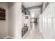 Inviting hallway featuring wainscoting, wood-look flooring, a charming bench seat, and serene color palette at 14296 W Surrey Dr, Surprise, AZ 85379