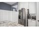 Kitchen featuring stainless steel refrigerator and granite countertops with white cabinetry at 14296 W Surrey Dr, Surprise, AZ 85379