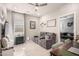 Living room with a gray reclining sofa and lots of natural light at 14296 W Surrey Dr, Surprise, AZ 85379