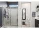 Bright ensuite bathroom with a glass-enclosed shower and a separate vanity area at 14296 W Surrey Dr, Surprise, AZ 85379