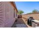 Cozy side yard with a stone walkway, creating a private outdoor space with ample sunlight at 14296 W Surrey Dr, Surprise, AZ 85379