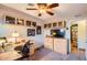 Bright home office featuring modern desk, storage cabinets, and ceiling fan for a comfortable workspace at 15034 N 54Th St, Scottsdale, AZ 85254