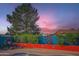 Unique poolside backyard decor featuring cacti, succulents, and a colorful sunset sky at 15034 N 54Th St, Scottsdale, AZ 85254