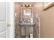 Charming powder room with a unique vessel sink, stone tile, and decorative mirror at 1541 E Hope St, Mesa, AZ 85203