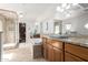 Luxurious bathroom featuring dual vanities, a soaking tub, a walk-in shower, and modern lighting fixtures at 1541 E Hope St, Mesa, AZ 85203