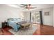 Bright bedroom featuring a ceiling fan, hardwood floors, and French doors to the exterior at 1541 E Hope St, Mesa, AZ 85203