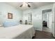 Well-lit bedroom featuring wood floors, ceiling fan, and mirrored closet doors at 1541 E Hope St, Mesa, AZ 85203