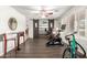 Home gym space features wood floors, sliding mirrored barn doors, a ceiling fan and natural light at 1541 E Hope St, Mesa, AZ 85203