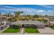 Expansive single-story home featuring lush landscaping, a basketball hoop, and a charming walkway to the entrance at 1541 E Hope St, Mesa, AZ 85203