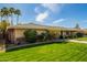 Exterior view of a home with mature landscaping, including a cactus, and a well-kept lawn at 1541 E Hope St, Mesa, AZ 85203