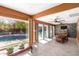 Sunlit living room with tile flooring, large windows with pool views, and a decorative stone accent wall at 1541 E Hope St, Mesa, AZ 85203