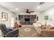 Inviting living room with a large built-in bookshelf, ceiling fan, and comfortable seating arrangement at 1541 E Hope St, Mesa, AZ 85203