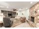 Comfortable living room featuring a stone fireplace, built-in shelving, and neutral-toned furniture at 1541 E Hope St, Mesa, AZ 85203