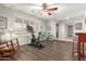 Versatile living space featuring wood floors, large window, ceiling fan, and neutral decor at 1541 E Hope St, Mesa, AZ 85203