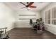 Bright home office with wood floors, shelving, and a ceiling fan at 1541 E Hope St, Mesa, AZ 85203