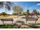 Community park featuring benches, a playground, mature trees, and walking paths at 1541 E Hope St, Mesa, AZ 85203