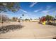 Community playground area with swings, slides, and climbing equipment on a sunny day at 1541 E Hope St, Mesa, AZ 85203