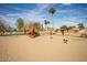 Playground in a community park featuring slides and other fun equipment on sand at 1541 E Hope St, Mesa, AZ 85203