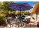 Inviting outdoor pool area featuring a patio table with chairs and a shade umbrella at 1541 E Hope St, Mesa, AZ 85203