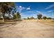 Sand volleyball court in a community park setting with surrounding greenery and blue sky at 1541 E Hope St, Mesa, AZ 85203