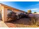 Exterior shot of the home's backyard with low-maintenance desert landscaping at 15601 W Hammond Dr, Goodyear, AZ 85338