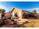 Home's backyard showcases a small decorative pond with rock features and patio at 15601 W Hammond Dr, Goodyear, AZ 85338