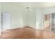 Bright bedroom featuring laminate floors, a ceiling fan and sliding glass doors at 15601 W Hammond Dr, Goodyear, AZ 85338