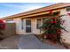 Welcoming home entrance with security door and a vibrant bougainvillea bush by the front door at 15601 W Hammond Dr, Goodyear, AZ 85338