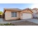 Attractive single-story home featuring a neutral stucco facade, tile roof, desert landscaping and long driveway at 15601 W Hammond Dr, Goodyear, AZ 85338