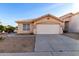 Charming single-story home featuring a neutral stucco facade, tile roof and well-maintained landscaping at 15601 W Hammond Dr, Goodyear, AZ 85338