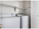 Laundry room featuring a washer, dryer, and built-in shelving at 15601 W Hammond Dr, Goodyear, AZ 85338