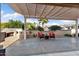 Relaxing covered patio featuring a fireplace, outdoor seating, and desert landscaping at 16200 W Hearthstone Dr, Surprise, AZ 85374