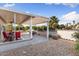 Backyard featuring a covered patio, outdoor seating, and desert landscaping at 16200 W Hearthstone Dr, Surprise, AZ 85374