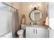 Bathroom featuring a shower and tub combination, decorative ladder with a sunflower, and granite countertop sink at 16200 W Hearthstone Dr, Surprise, AZ 85374