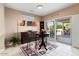 Bright dining area features sliding doors to the patio, stylish rug, and elegant furnishings at 16200 W Hearthstone Dr, Surprise, AZ 85374