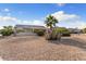 Well-maintained front yard with desert landscaping and covered patio at 16200 W Hearthstone Dr, Surprise, AZ 85374