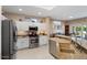 Bright kitchen with white cabinetry, granite countertops, and stainless steel appliances at 16200 W Hearthstone Dr, Surprise, AZ 85374