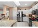 Bright kitchen with white cabinetry, granite countertops, and stainless steel appliances at 16200 W Hearthstone Dr, Surprise, AZ 85374