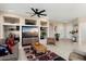 Comfortable living room features built-in shelving, tile flooring, and stylish decor for relaxed living at 16200 W Hearthstone Dr, Surprise, AZ 85374