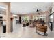 Bright and airy living room featuring tile floors, a ceiling fan, and large sliding glass doors to the patio at 16200 W Hearthstone Dr, Surprise, AZ 85374