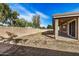 Backyard featuring block wall and covered patio with sliding glass doors to home at 17192 W Post Dr, Surprise, AZ 85388