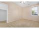 Bright bedroom with carpet, ceiling fan, and natural light from the window at 17192 W Post Dr, Surprise, AZ 85388