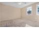 Bedroom with carpet, ceiling fan, and a window at 17192 W Post Dr, Surprise, AZ 85388